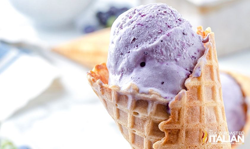 waffle cone with scoop of blueberry ice cream