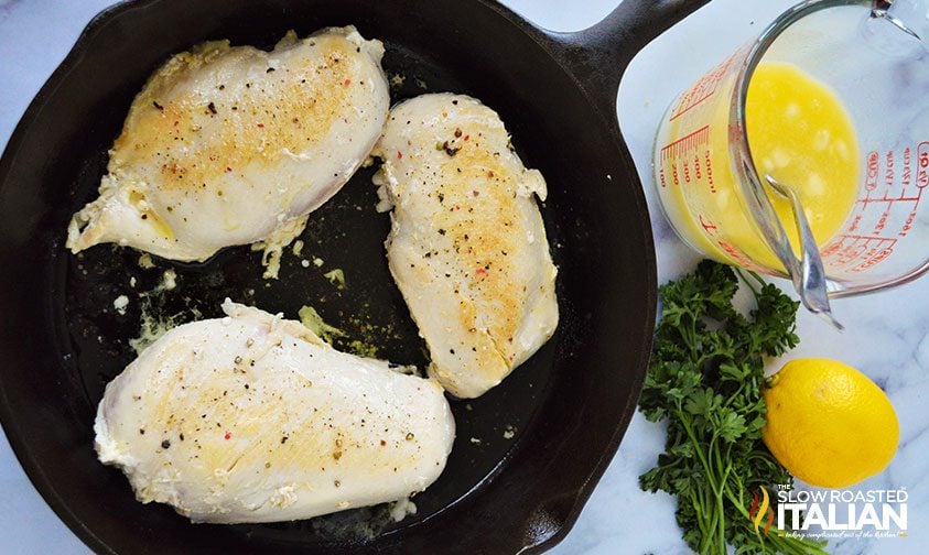 seasoned chicken breasts in cast iron skillet