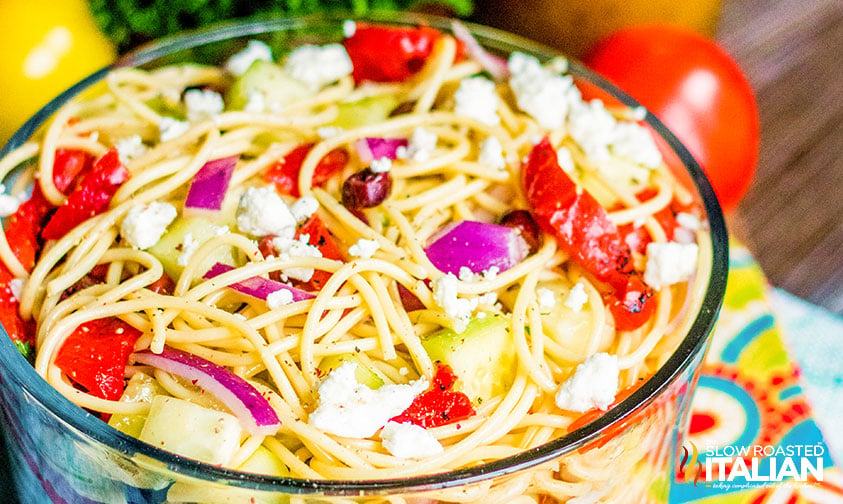 close up: cold spaghetti salad with tomatoes, olives, and feta