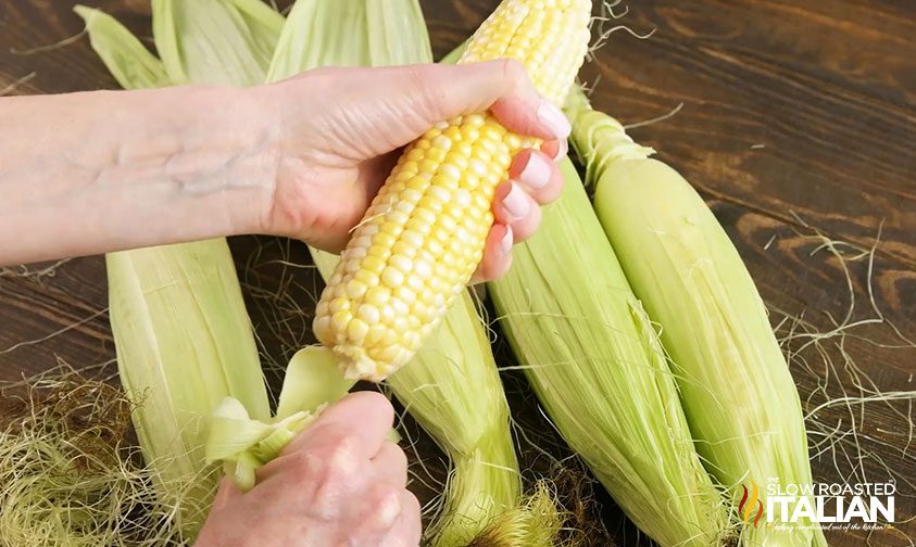 removing husks and silks from ears of corn