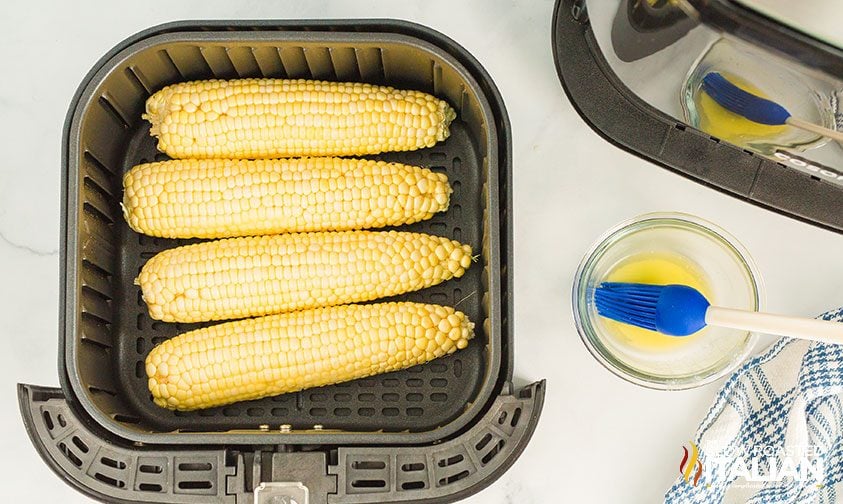 four ears of corn in air fryer basket