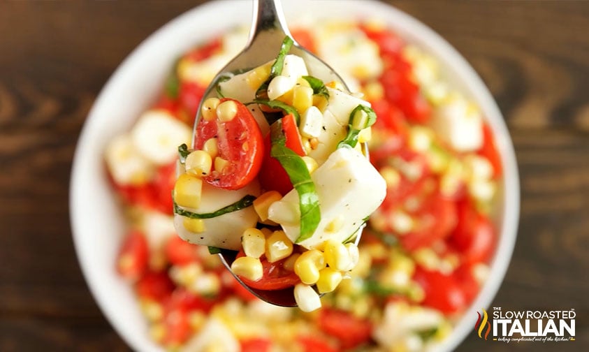close up: spoonful of summer corn salad with cheese