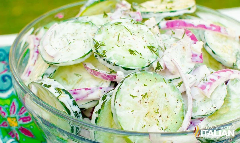 bowl of cucumber salad with mayo and dill