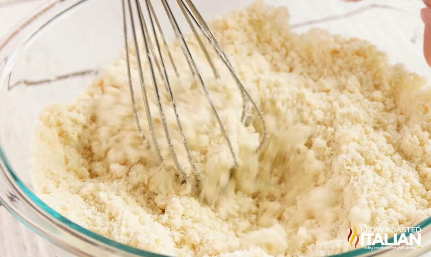 whisking cake batter in bowl