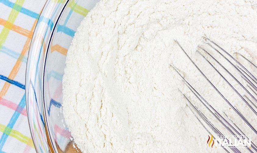 whisking flour in bowl