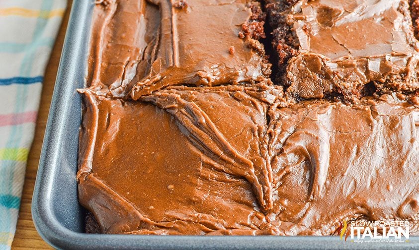 close up of sliced fudge cake in pan