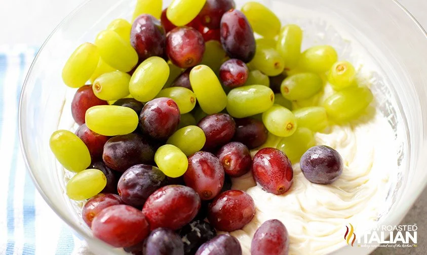 red and green grapes in bowl with cheesecake filling