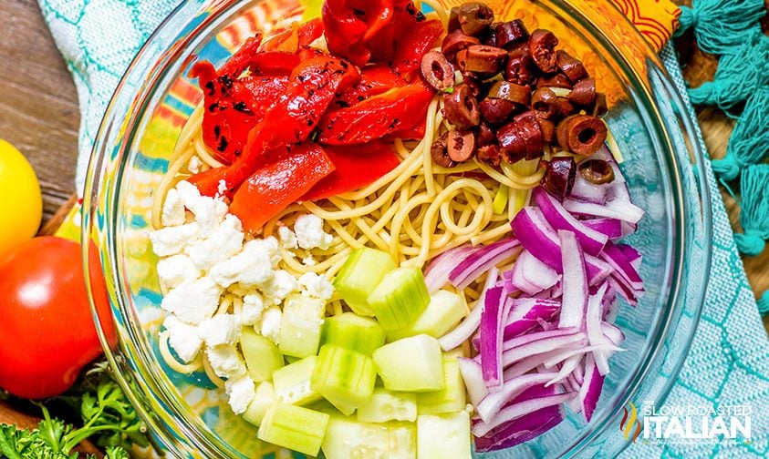 greek pasta salad ingredients in bowl