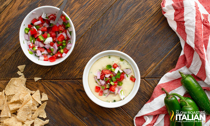 small bowl of cheese dip topped with pico from another bowl