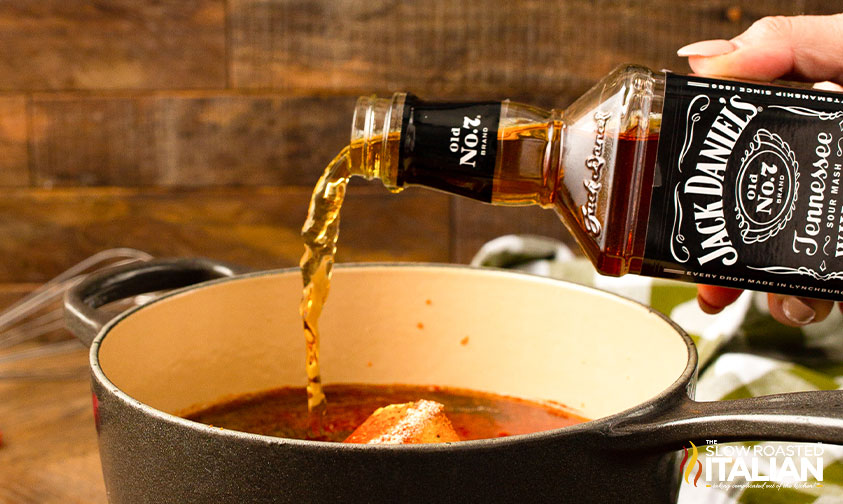 pouring Jack Daniels whiskey into sauce pan