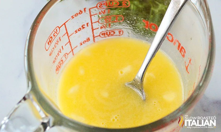 lemon butter sauce in measuring cup