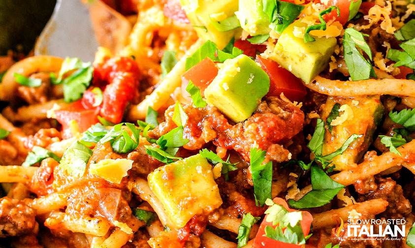 close up: chunks of avocado and tomato in taco pasta