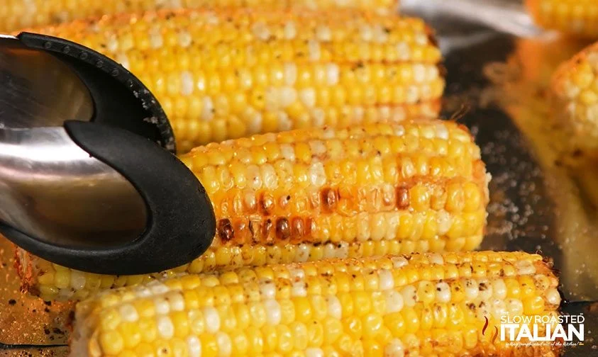 flipping corn in oven with tongs