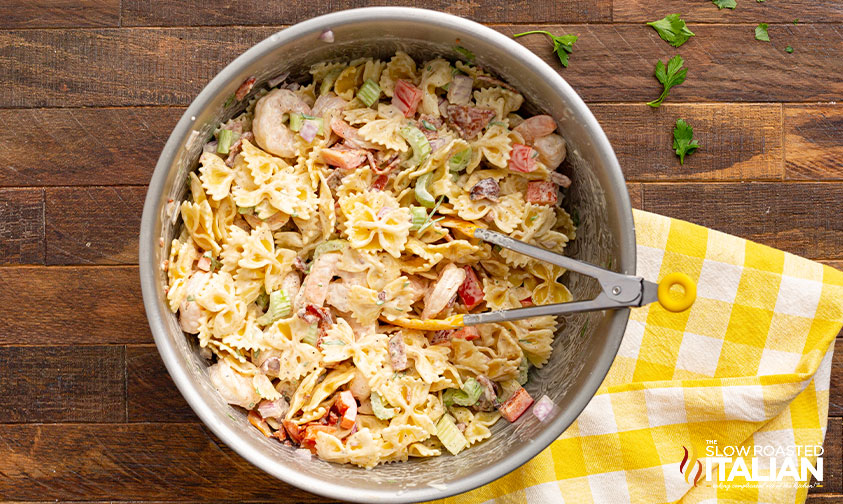 large bowl of pasta salad with tongs
