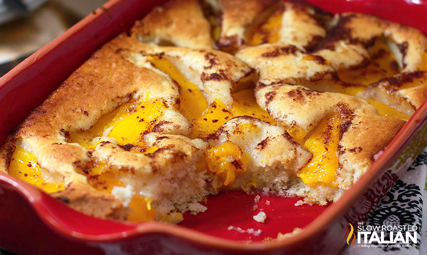 peach cobbler dump cake in red baking dish