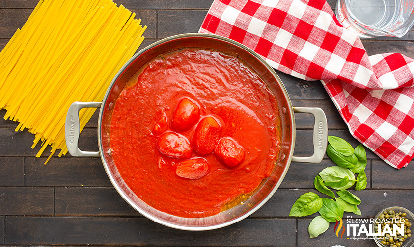 crushed and whole peeled tomatoes in skillet