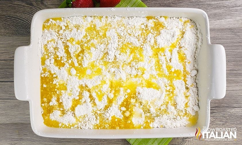 melted butter drizzled all over powdered cake mix in baking pan