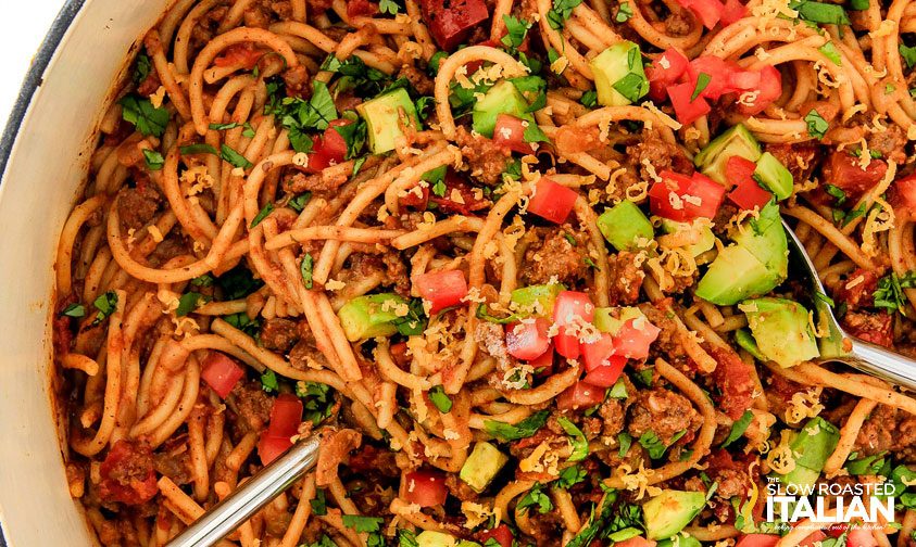 serving utensils in pot of taco spaghetti