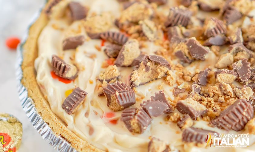no bake peanut butter cheesecake topped with chopped reeses cups