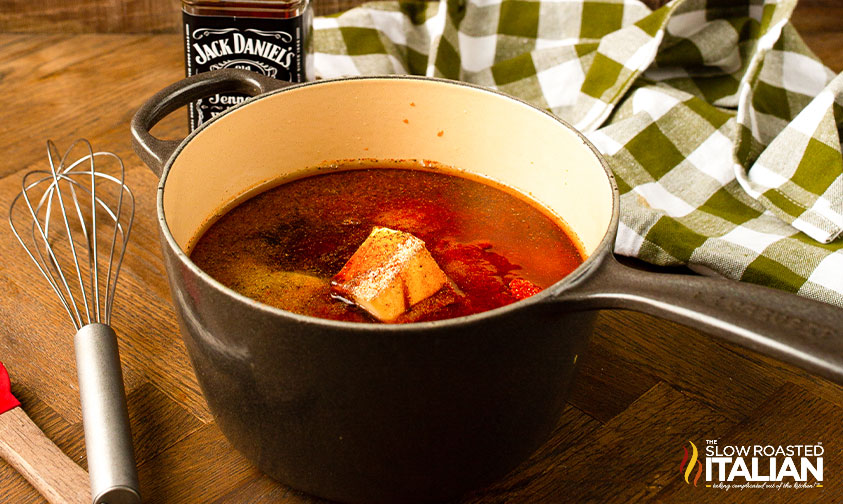 whisk next to saucepan with bbq sauce ingredients