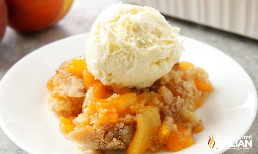 plate of southern peach cobbler with ice cream on top