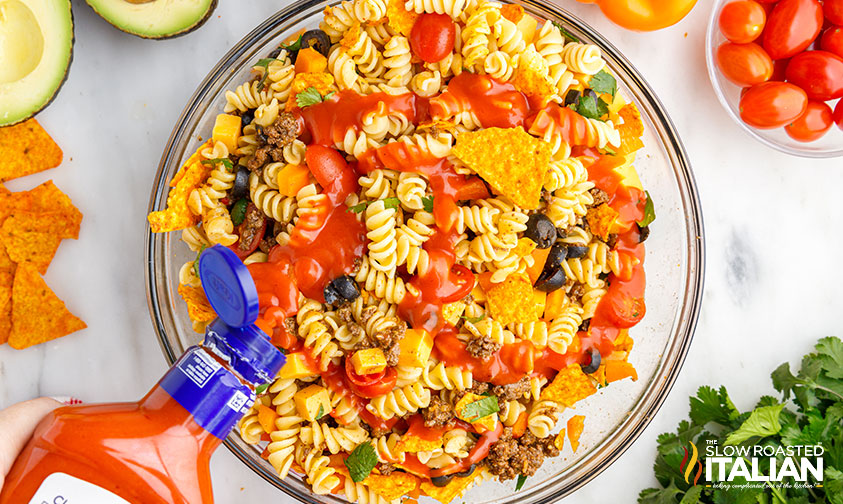 adding catalina dressing to taco salad with pasta