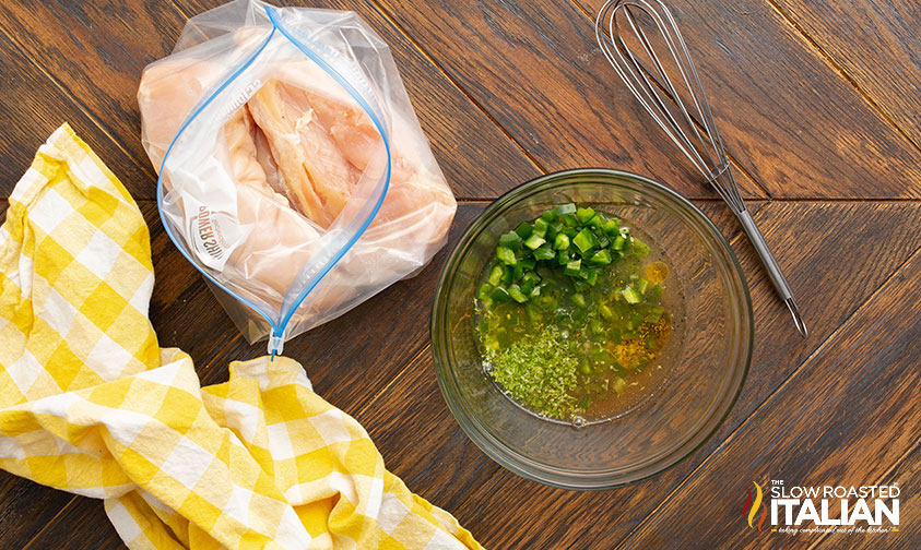 chicken in ziploc next to bowl of tequila marinade