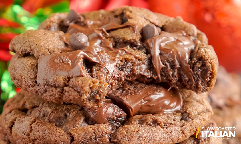 stacked chocolate cookies with a bite missing from the top one