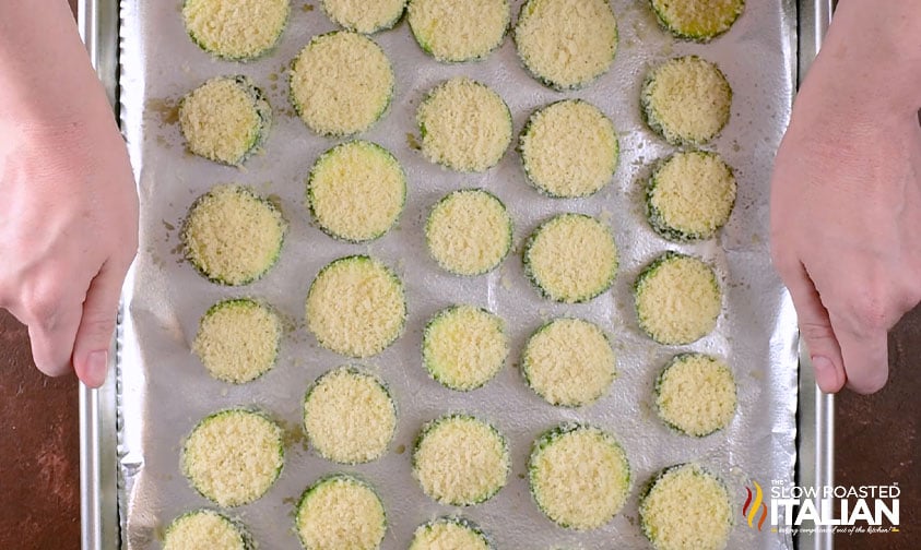 breaded zucchini slices on foil lined baking sheet