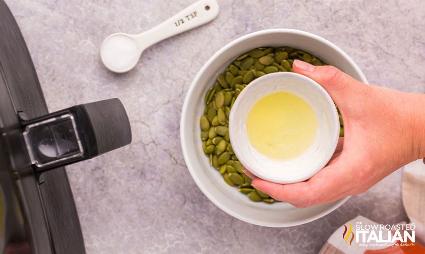 adding butter to pumpkin seeds