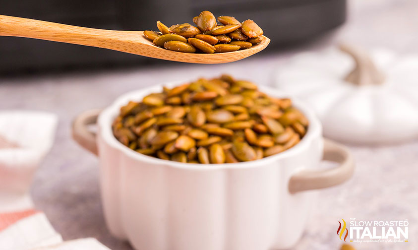 air fryer pumpkin seeds in a wooden spoon