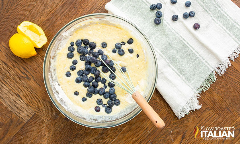 adding fresh blueberries to batter