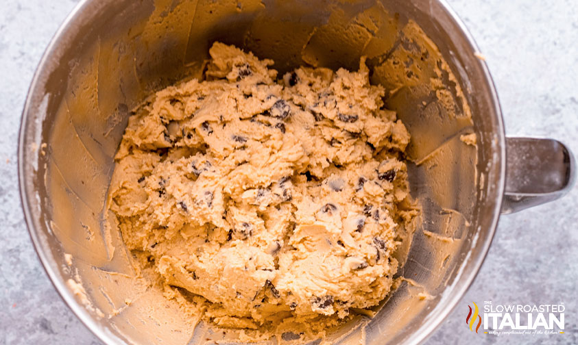 chocolate chips added to cookie dough in mixing bowl