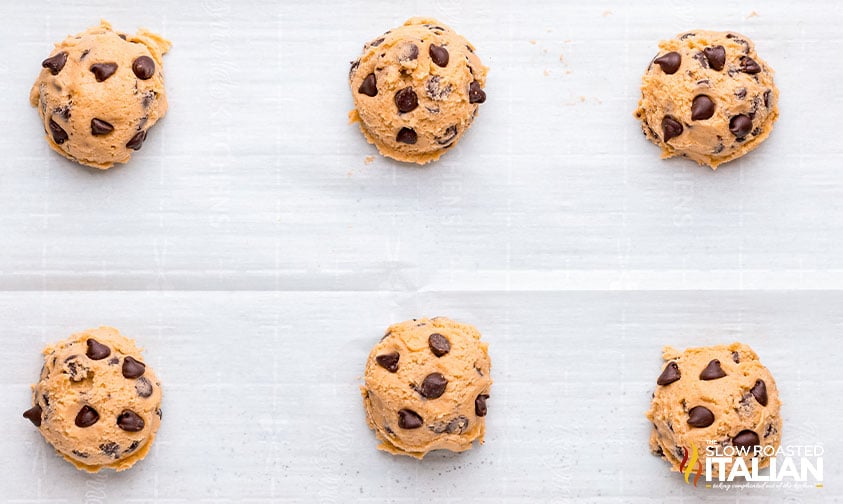 scooped cookie dough on parchment paper