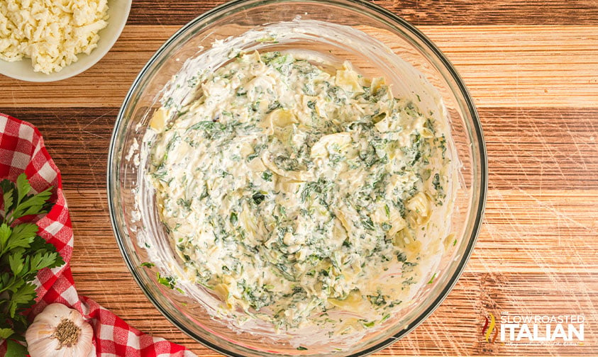mixed spinach artichoke dip in a glass bowl