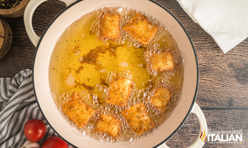 breaded ravioli frying in oiol