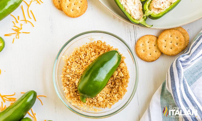 stuffed pepper face down in cracker crumbs