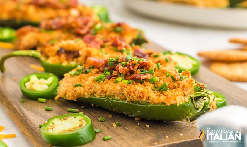 jalapeno poppers stuffed with cheese and topped with cracker crumbs and bacon