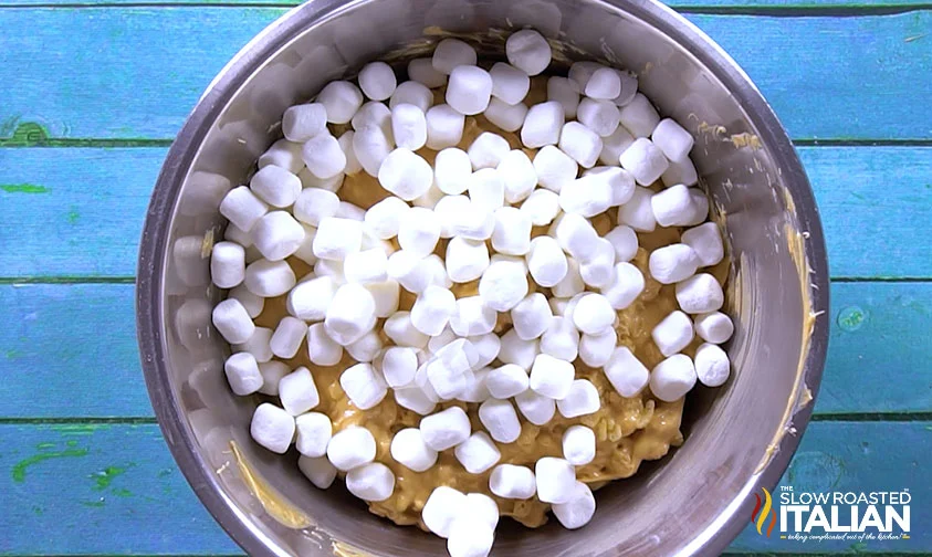 mini marshmallows scattered over avalanche cookie dough in bowl