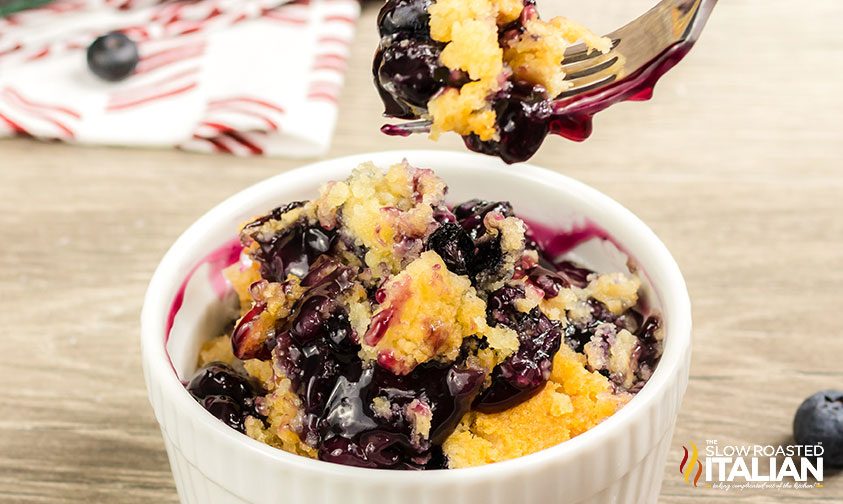 lifting forkful of cake out of ramekin