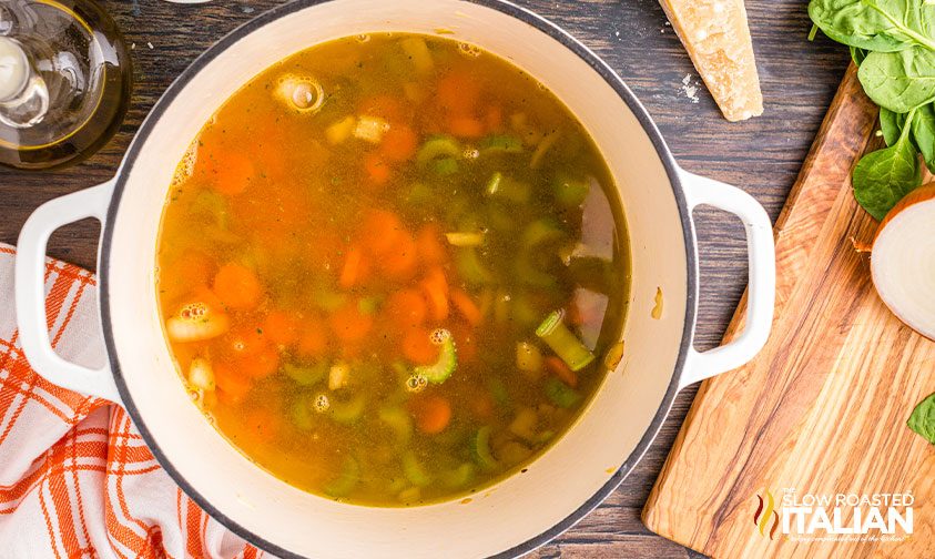 pot of chopped carrots, onion, and celery in broth