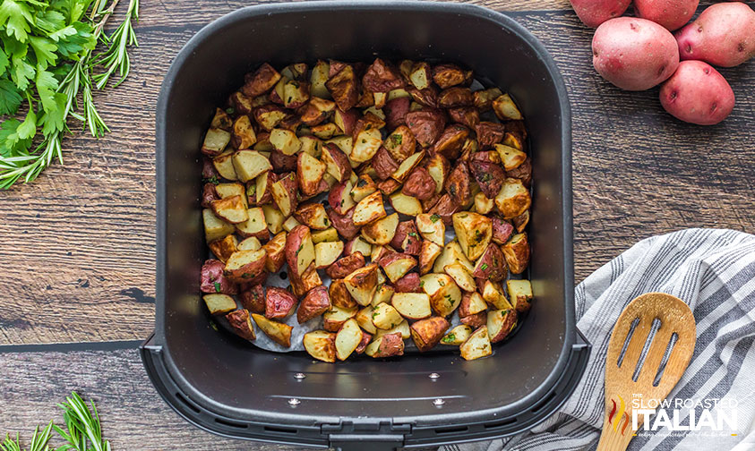 crispy red potato pieces in air fryer basket