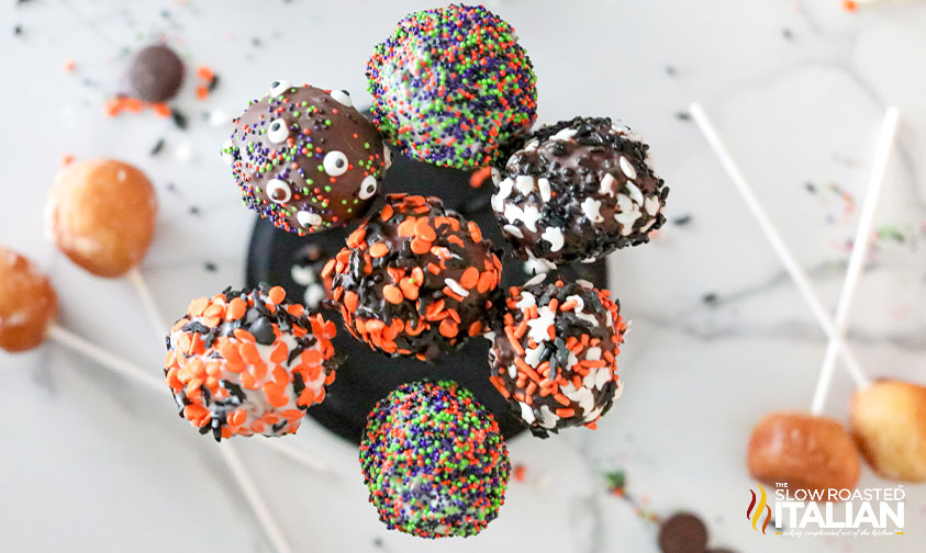 overhead: cake pops coated in different halloween sprinkles