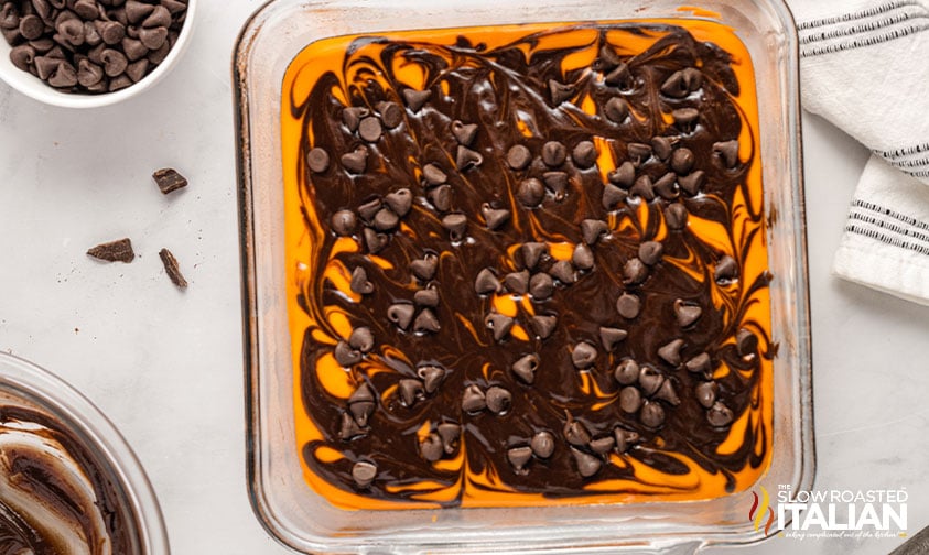 brownie batter swirled into cheesecake layer topped with chocolate chips