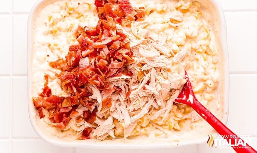 stirring chicken and bacon into cheesy ranch pasta bake