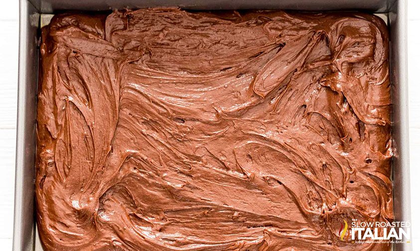 chocolate cake batter spread into metal pan