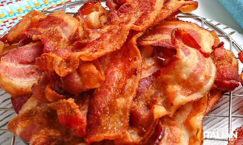 closeup: cooked air fryer bacon stacked on wire rack