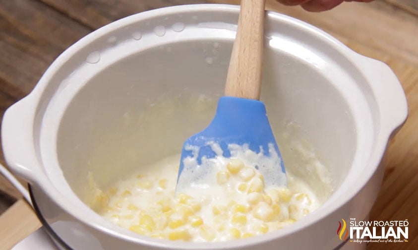 stirring cream corn ingredients in slow cooker