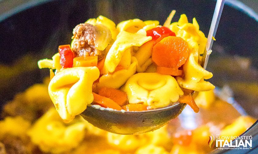 ladle full of tortellini soup