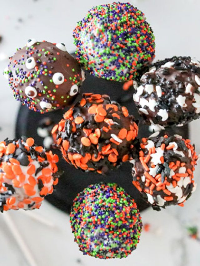 overhead: cake pops coated in different halloween sprinkles